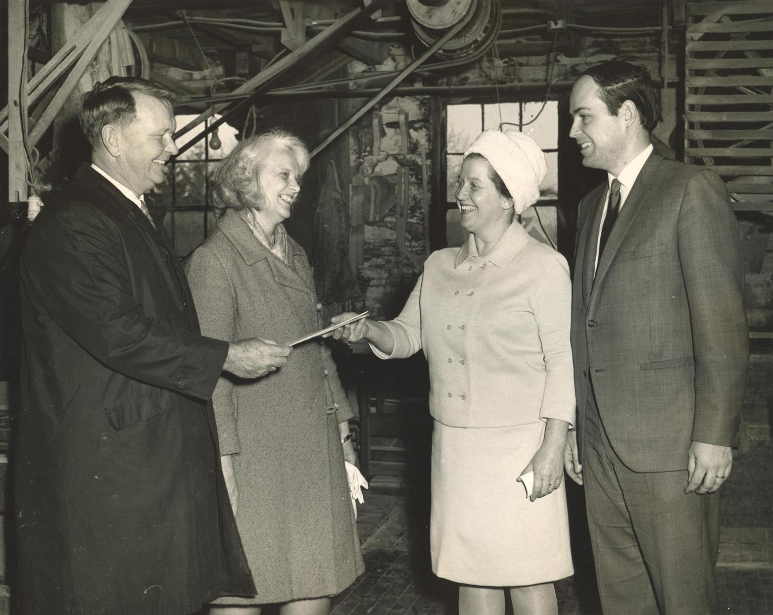 Patricia Fitzmaurice (second from right) receiving the deed to the Old Schwamb Mill